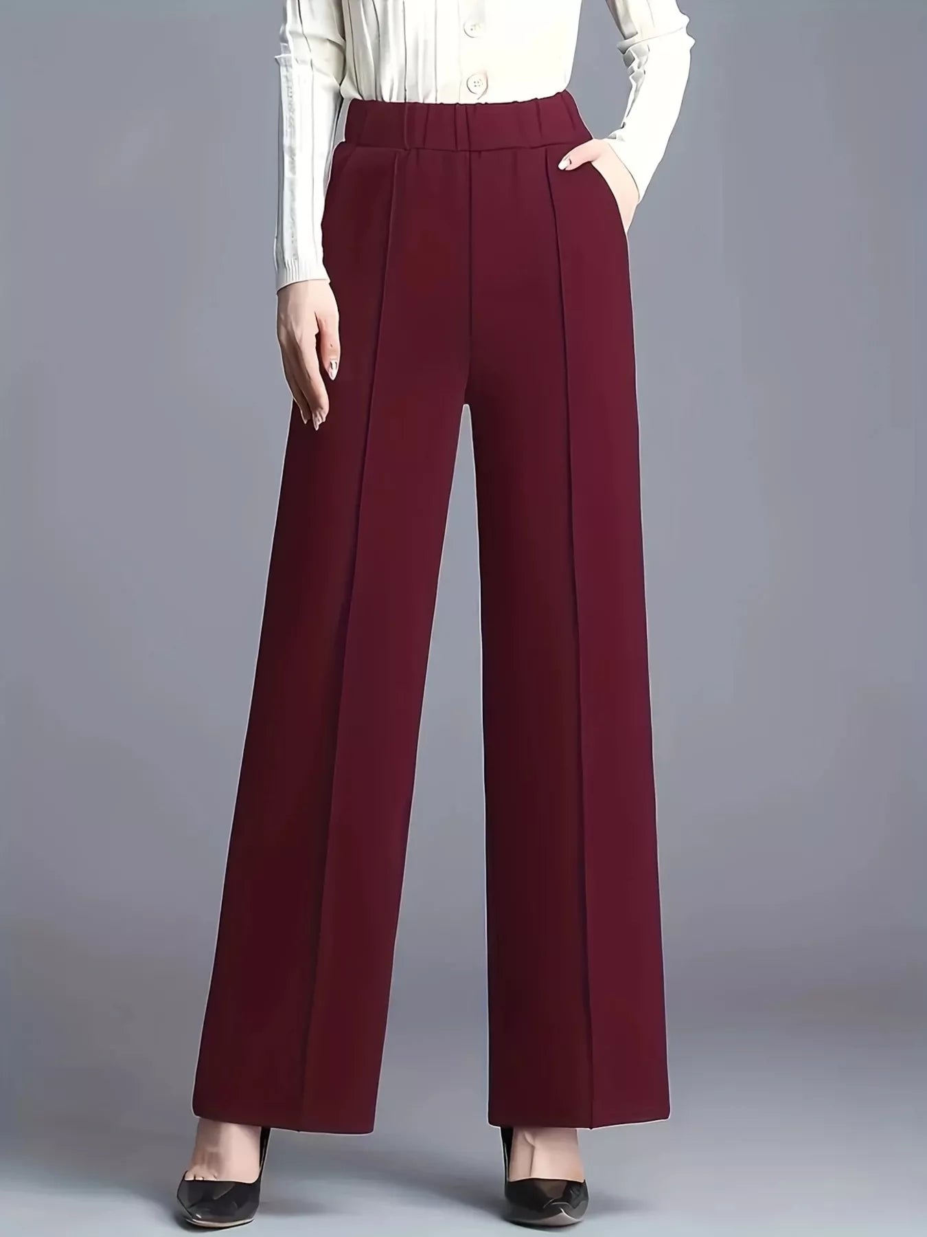 Maroon wide-leg pants worn by a person on a gray background
