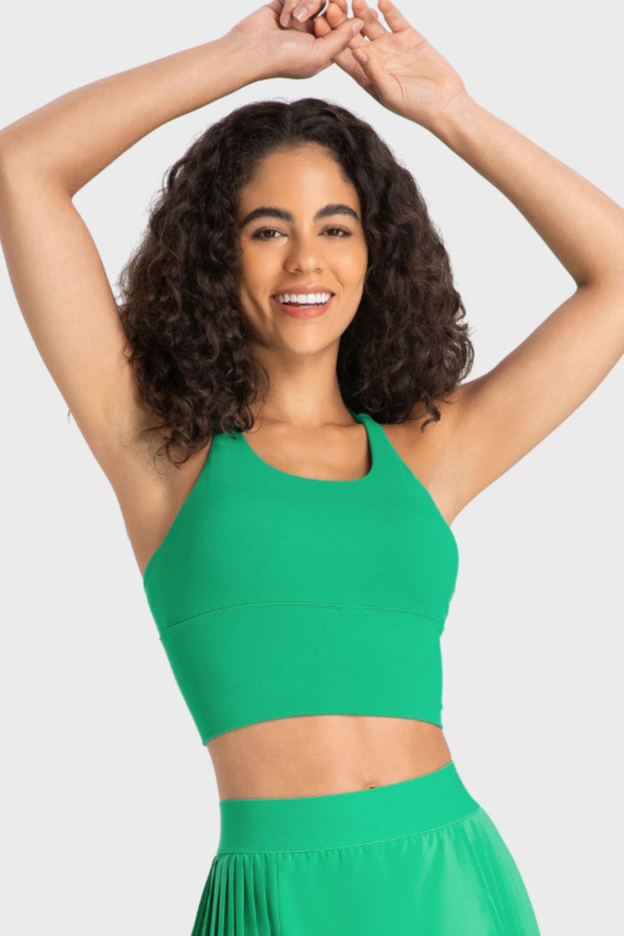 Woman wearing a green outfit against a plain background