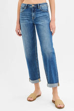 Person wearing blue jeans on a white background