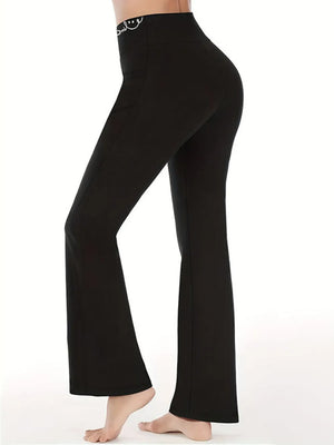 Black bell-bottom pants worn by a person on a white background