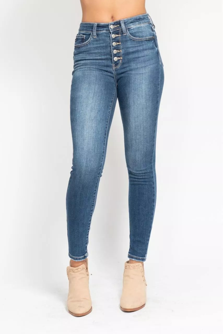 Blue jeans with button fly on a white background