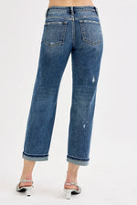 Blue jeans worn by a person on a white background