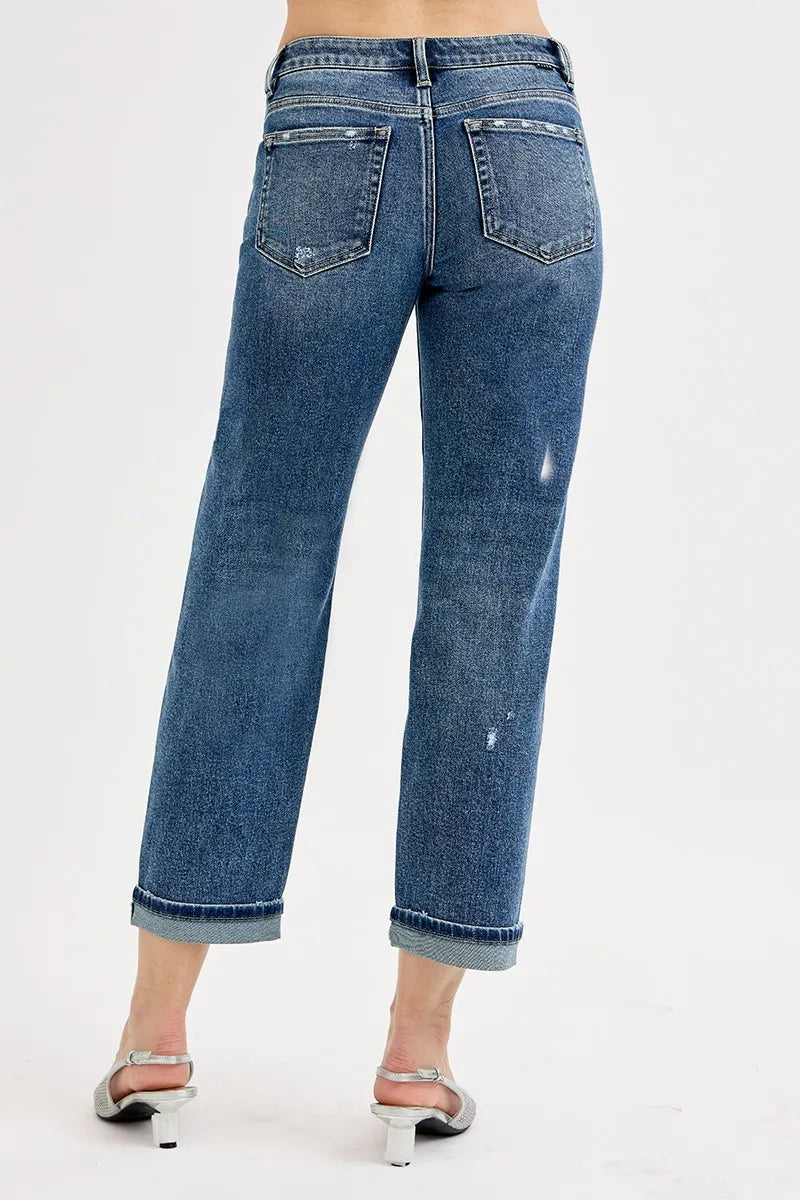 Blue jeans worn by a person on a white background