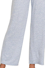 Close-up of light gray pants on a white background