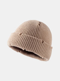 Beige knit beanie on a white background