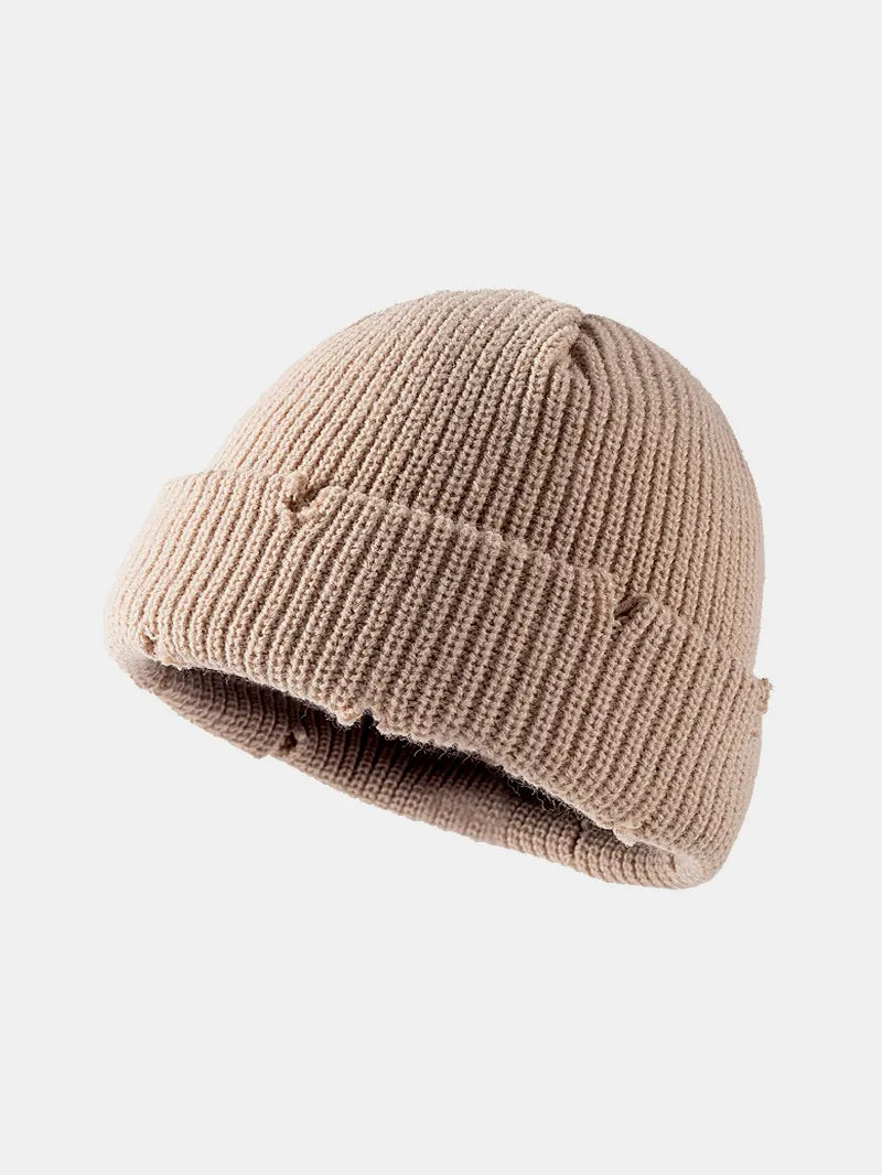 Beige knit beanie on a white background