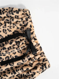 Leopard print fabric with black drawstring on a light gray background