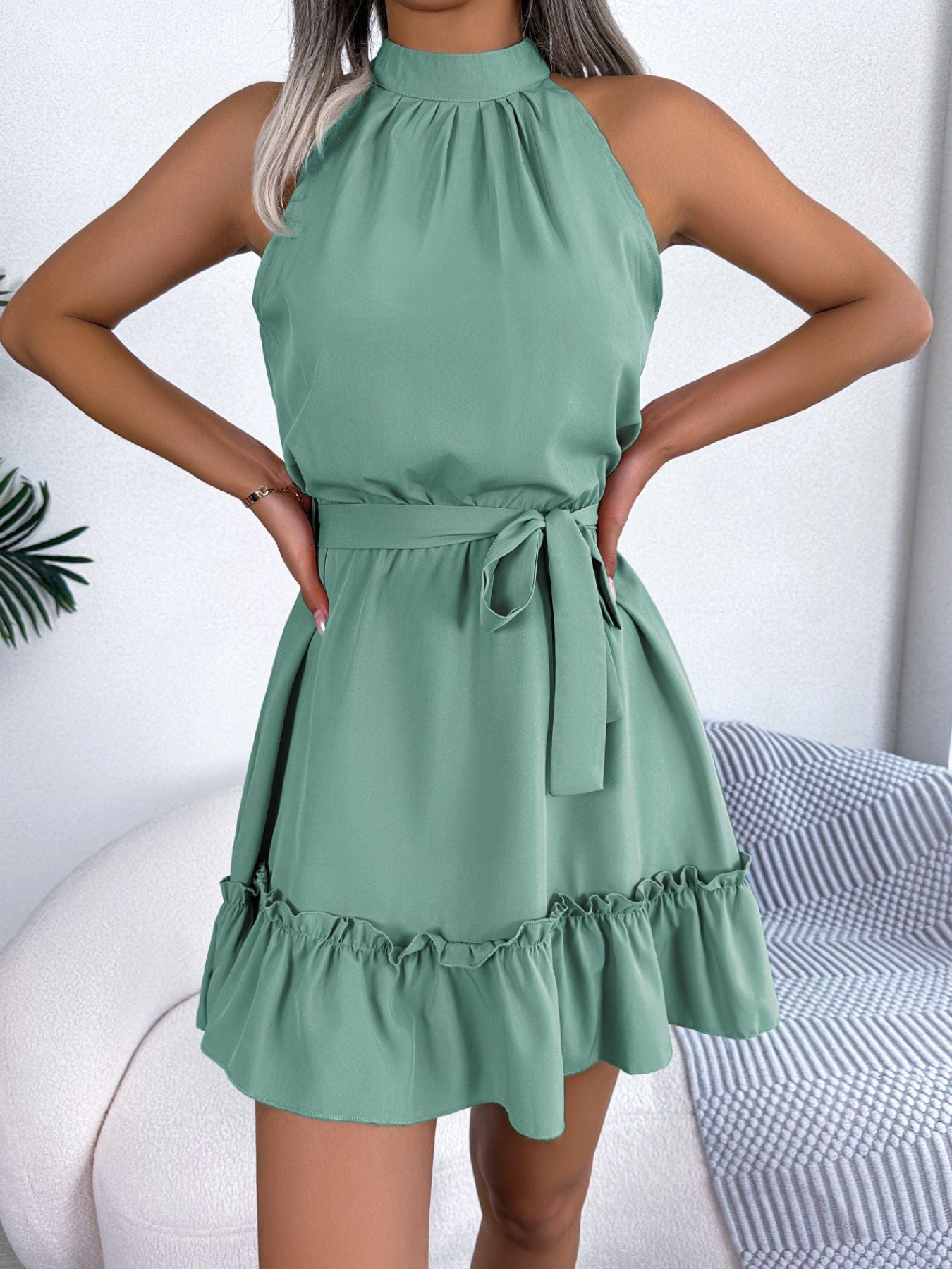 Woman wearing a green dress with a white background
