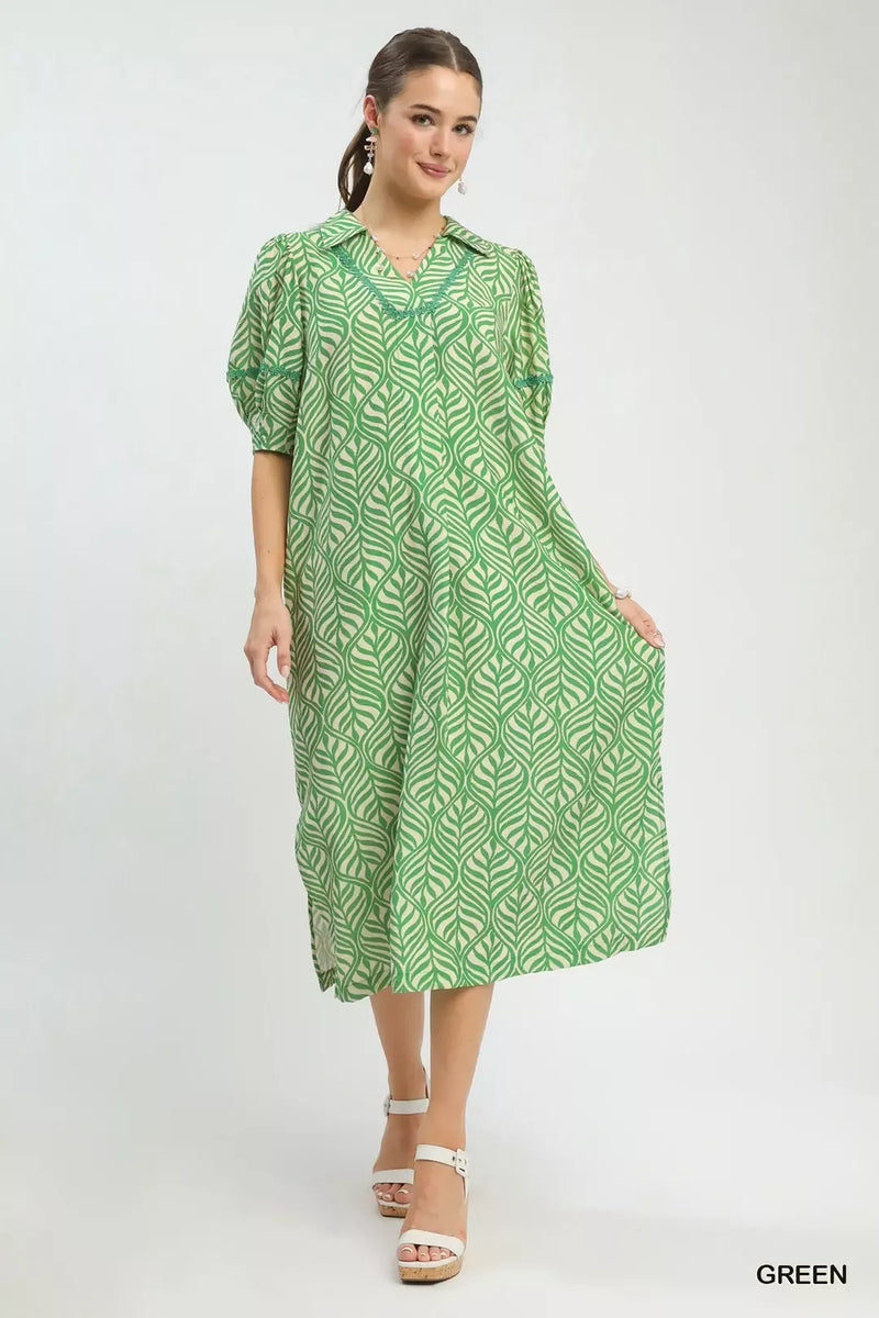 Woman wearing a green patterned dress on a white background