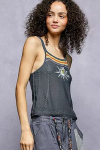 Woman wearing a tank top with a design on a gray background