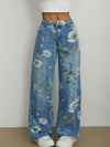 Blue floral jeans worn by a person on a plain background