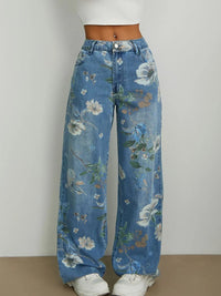 Blue floral jeans worn by a person on a plain background