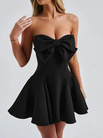 Black strapless dress with a large bow detail on a white background