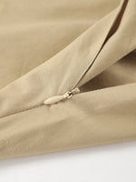 Close-up of a beige fabric with a zipper on a white background