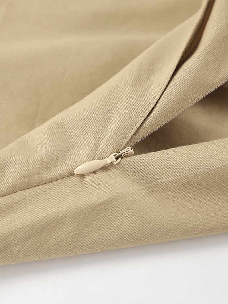 Close-up of a beige fabric with a zipper on a white background