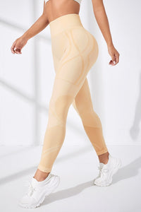 Person wearing beige leggings on a white background