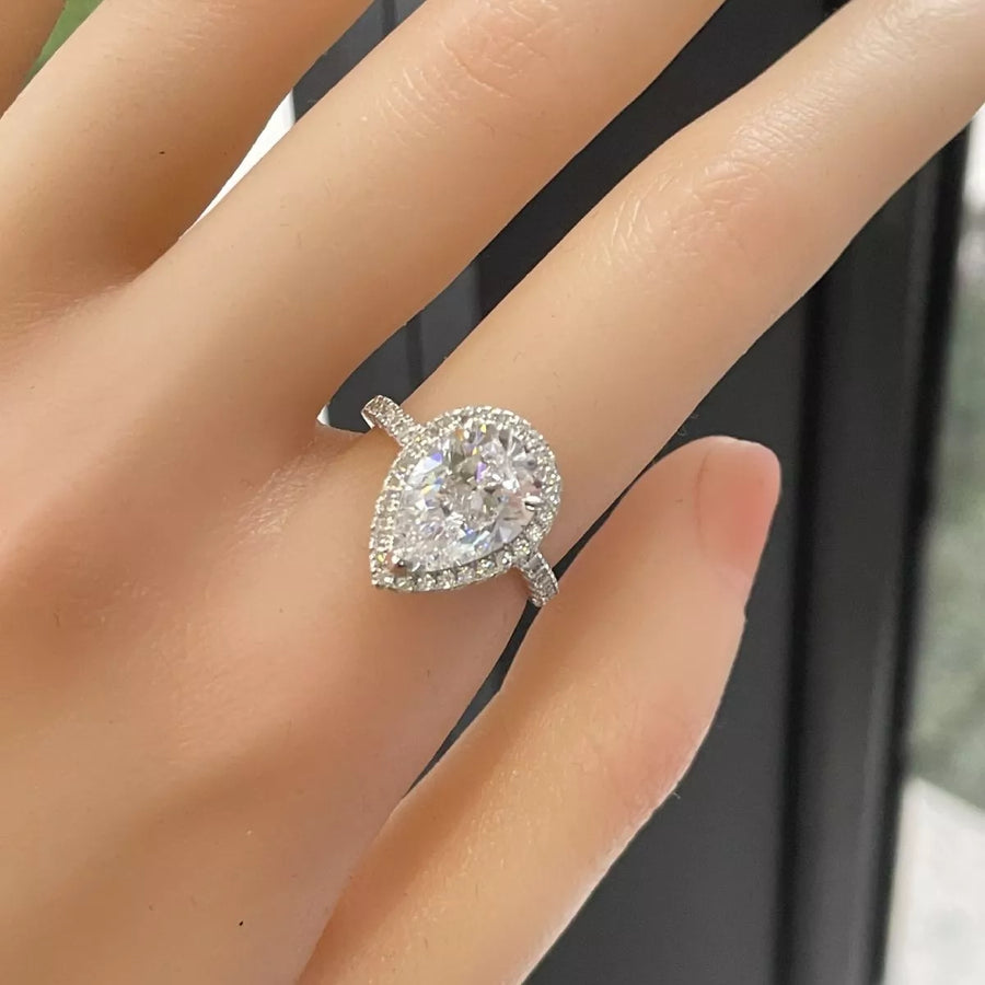Diamond ring on a hand with a blurred background