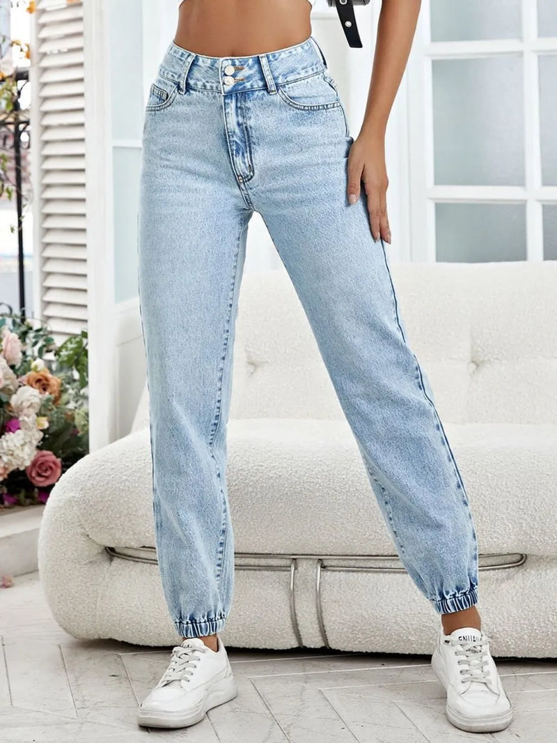 Light blue jeans worn by a person in an indoor setting with a neutral background