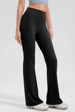 Person wearing black high-waisted pants on a white background