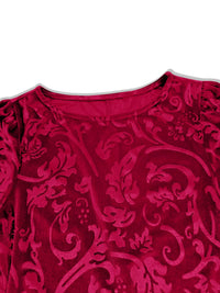 Close-up of a red patterned garment with a white background