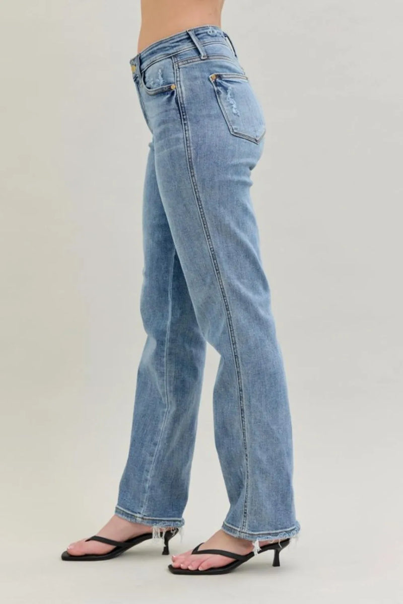 Light blue jeans worn by a person on a plain background