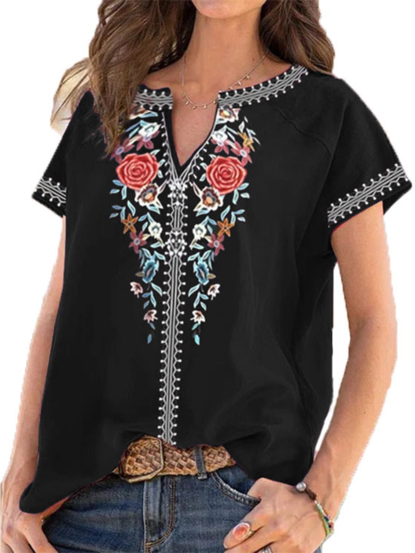 Black blouse with floral embroidery on a white background