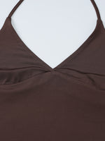 Close-up of a brown top with thin straps on a white background