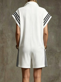 White sleeveless dress with black stripes on a textured gray background