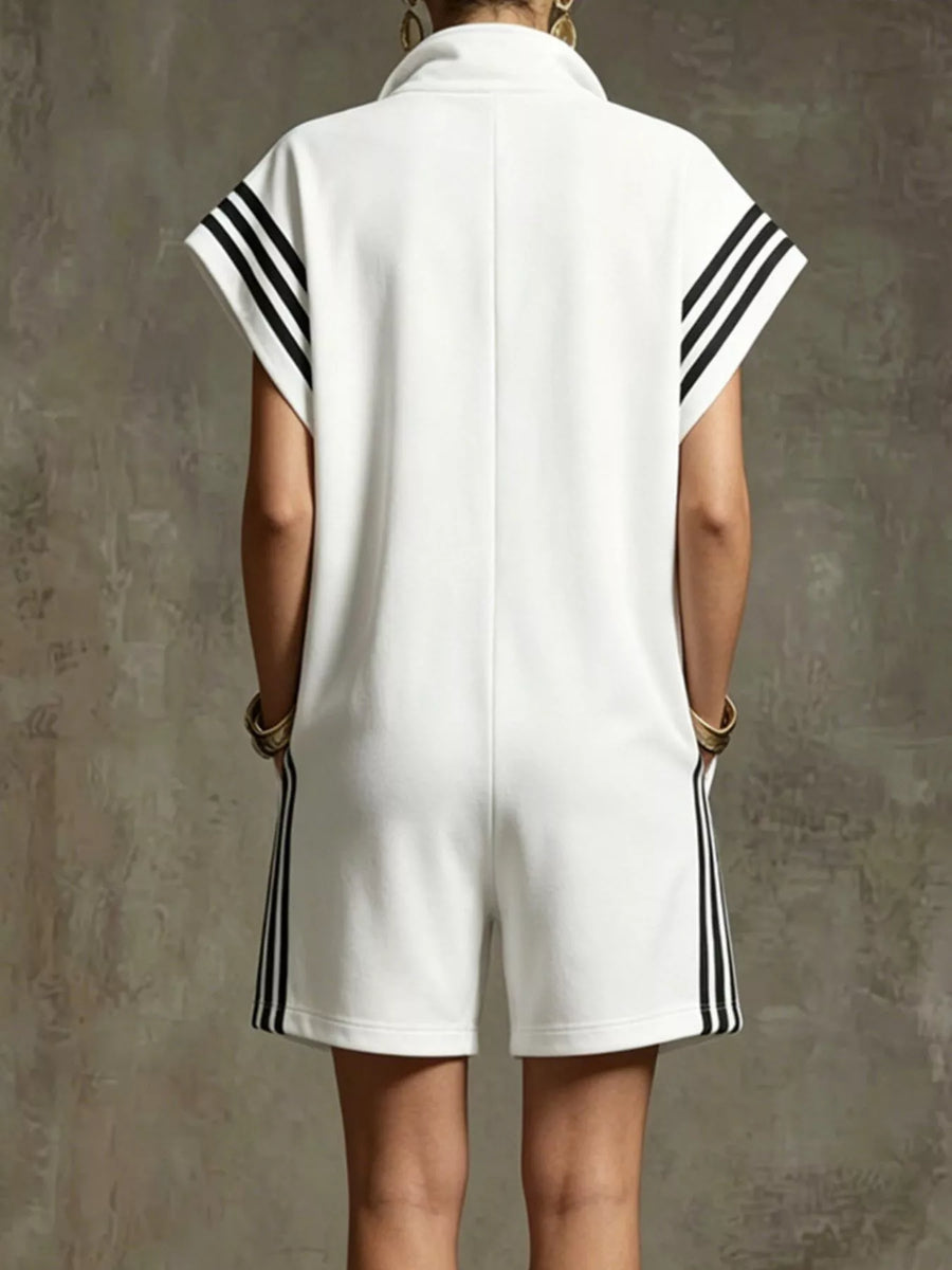 White sleeveless dress with black stripes on a textured gray background