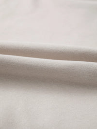 Close-up of beige fabric with a subtle texture