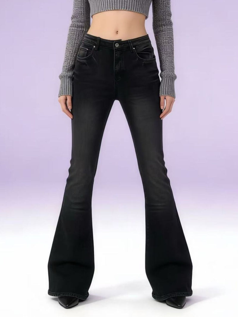 Black flared jeans worn by a person on a white background