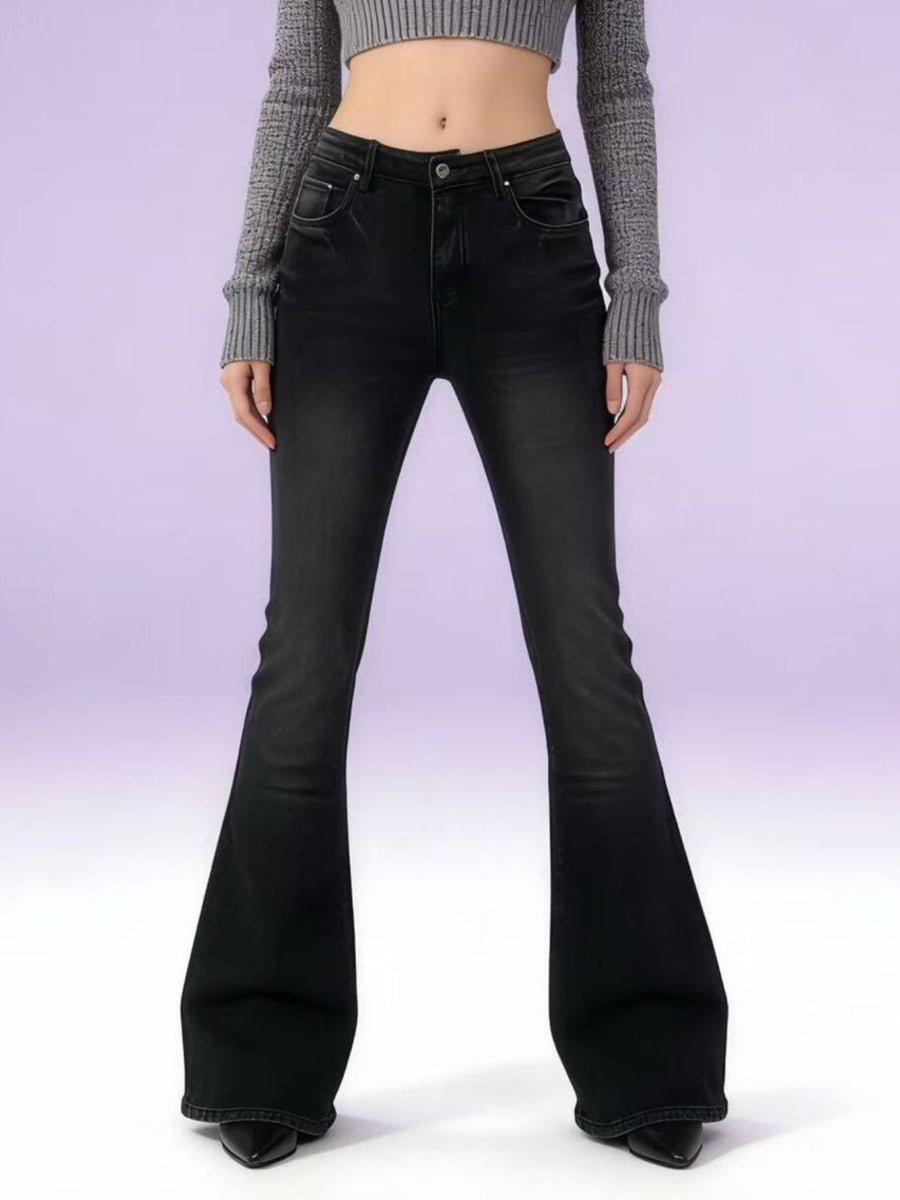 Black flared jeans worn by a person on a white background