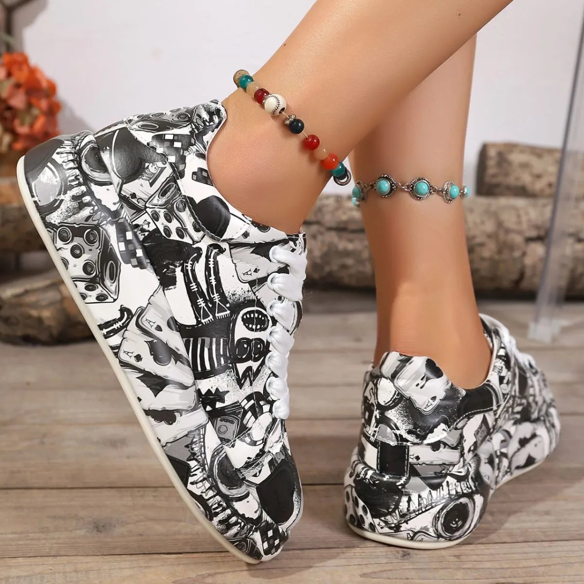 Black and white patterned shoes worn by a person on a wooden floor.