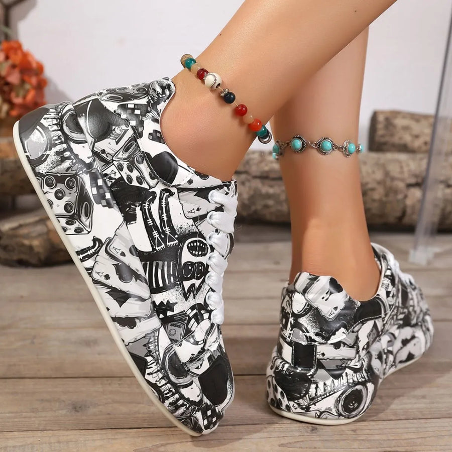 Black and white patterned shoes worn by a person on a wooden floor.