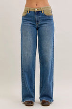 Blue jeans with a beige waistband on a white background