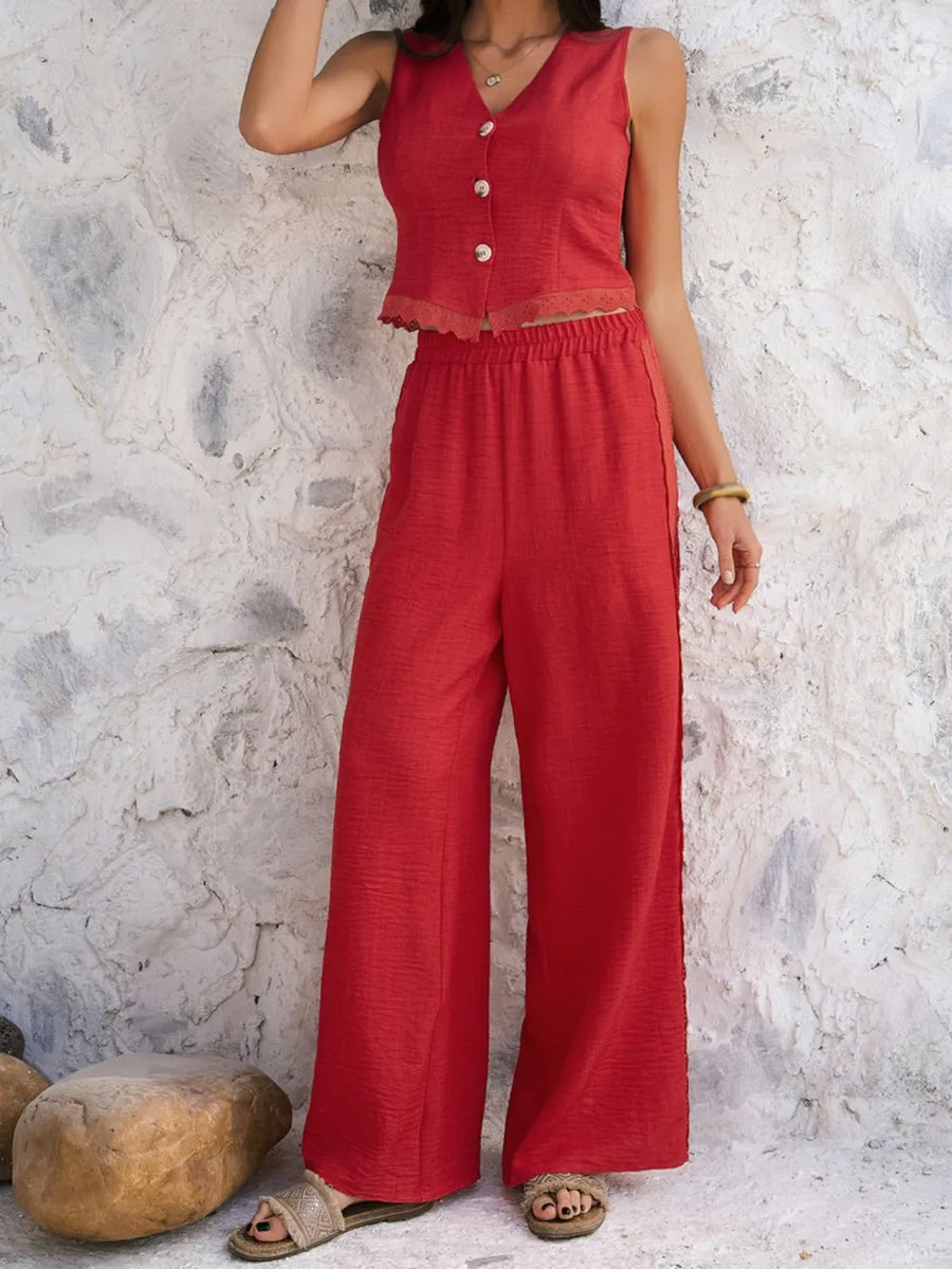 Person wearing a red outfit against a textured stone wall.