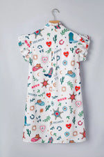 Children's dress with colorful patterns on a gray background