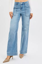 Light blue jeans worn by a person on a white background