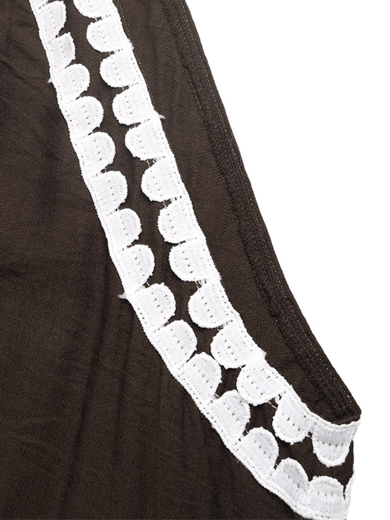 Brown fabric with white lace trim on a white background