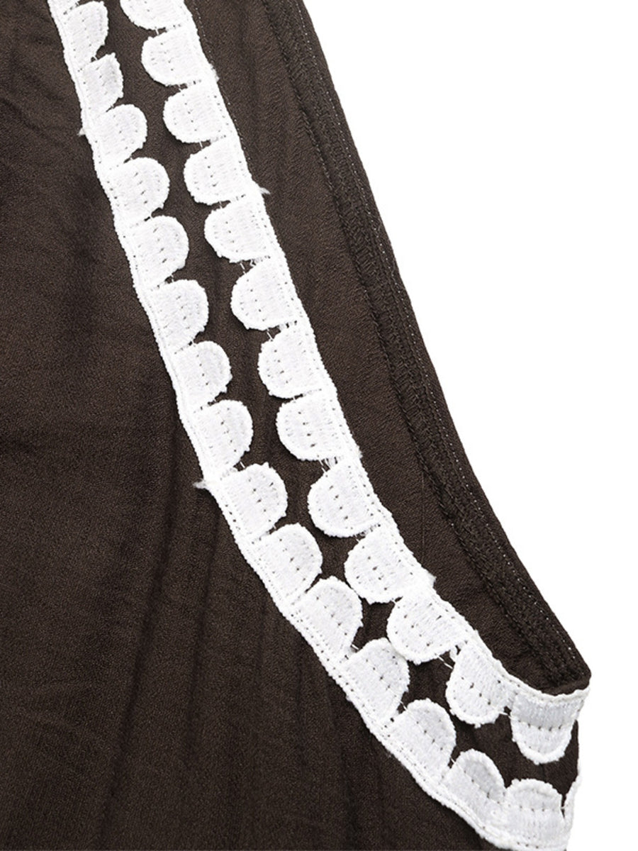 Brown fabric with white lace trim on a white background