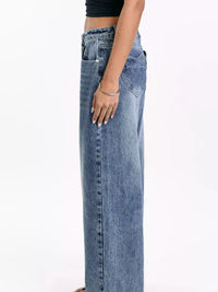 Person wearing blue jeans on a white background