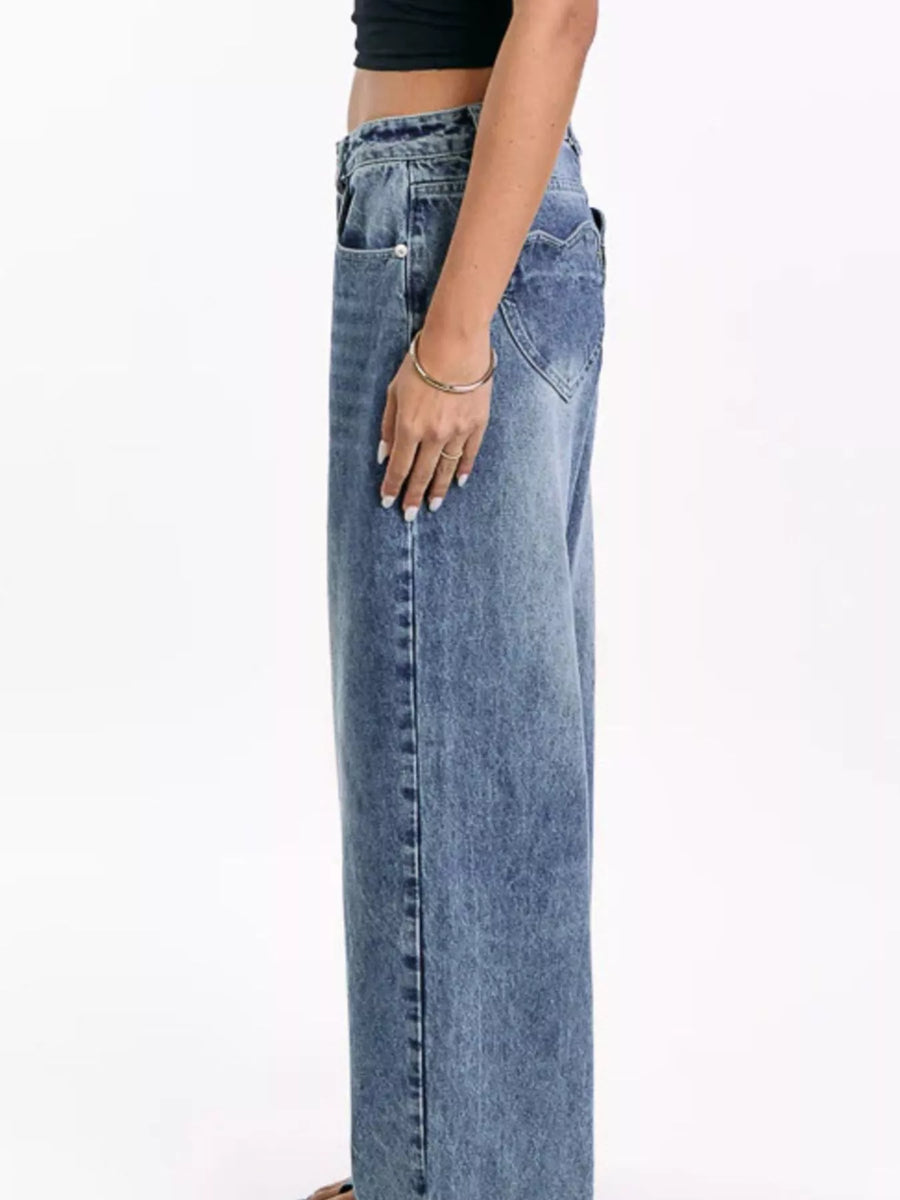 Person wearing blue jeans on a white background