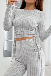 Person wearing a gray ribbed outfit with a matching top and pants.
