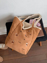 Brown tote bag with animal prints on a wooden floor