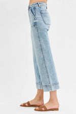 Light blue jeans worn by a person on a white background