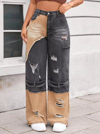 Person wearing a unique jeans design with patchwork effect in front of a building.