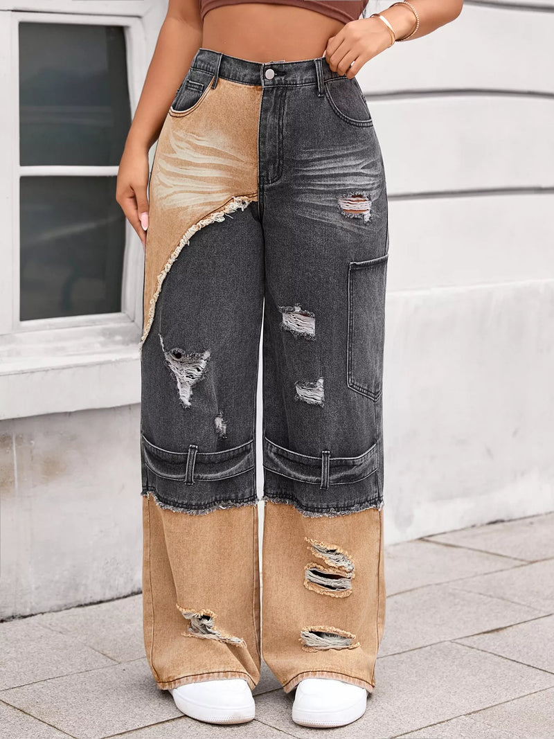 Person wearing a unique jeans design with patchwork effect in front of a building.