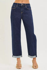 Blue jeans worn by a person on a white background