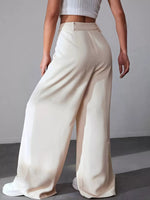 Person wearing beige wide-leg pants against a plain background