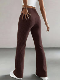 Brown ribbed pants worn by a person on a plain background